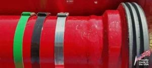 Stainless steel strapping around a bright red cylindrical industrial object